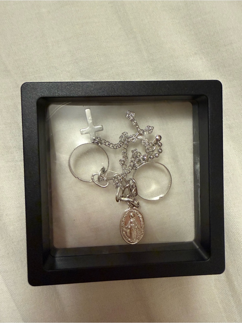Two silver tone rings with crosses and medal NEW